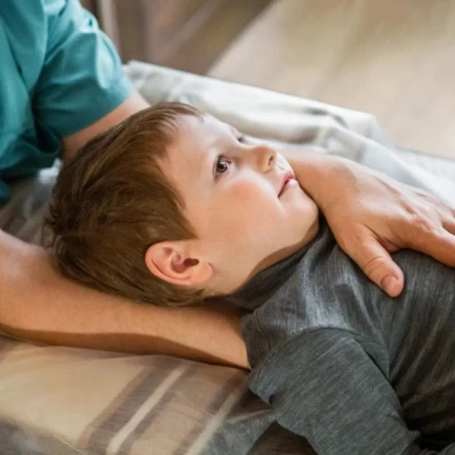 Young boy lying comfortably during a clinical examination at a practice in Coburg, Melbourne.
