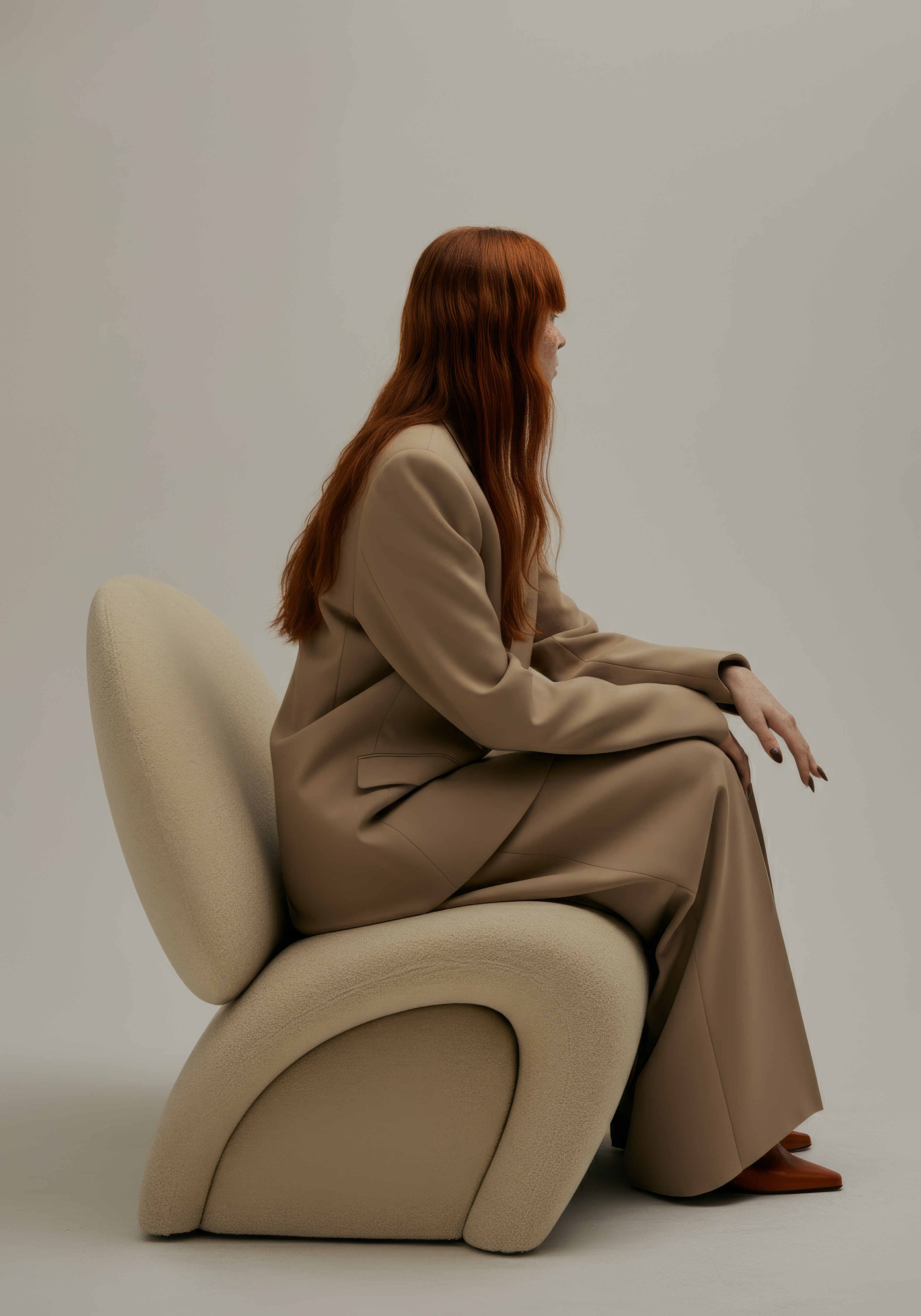 studio image of a lady sitting on a cool sofa