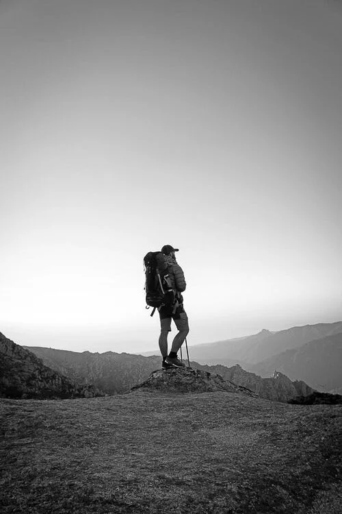 Hiker at the top of a mountain in Corsica