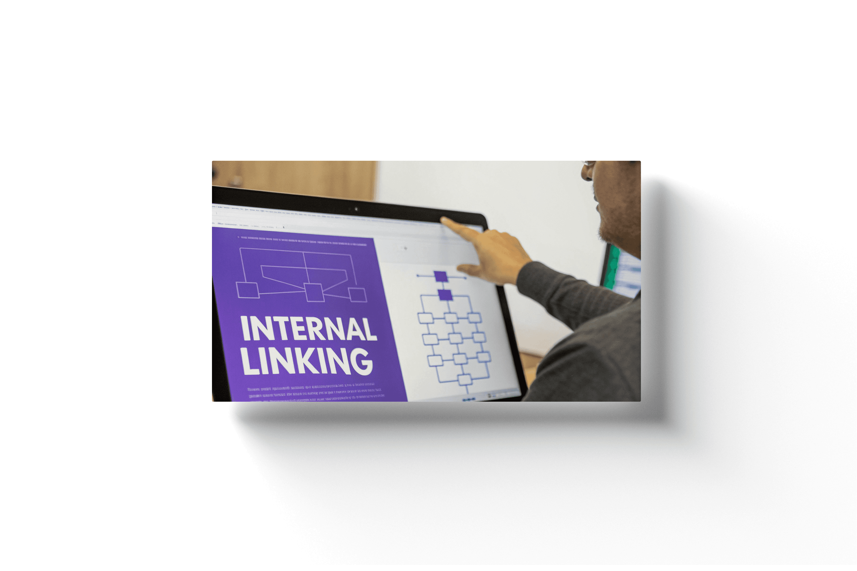a man using a touch screen device with the text 'internal linking' displayed on a purple part of the screen