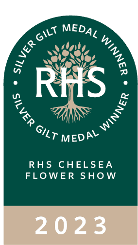 Logo of the RHS Chelsea Flower Show 2023, featuring a tree symbol and event details within a circular design.