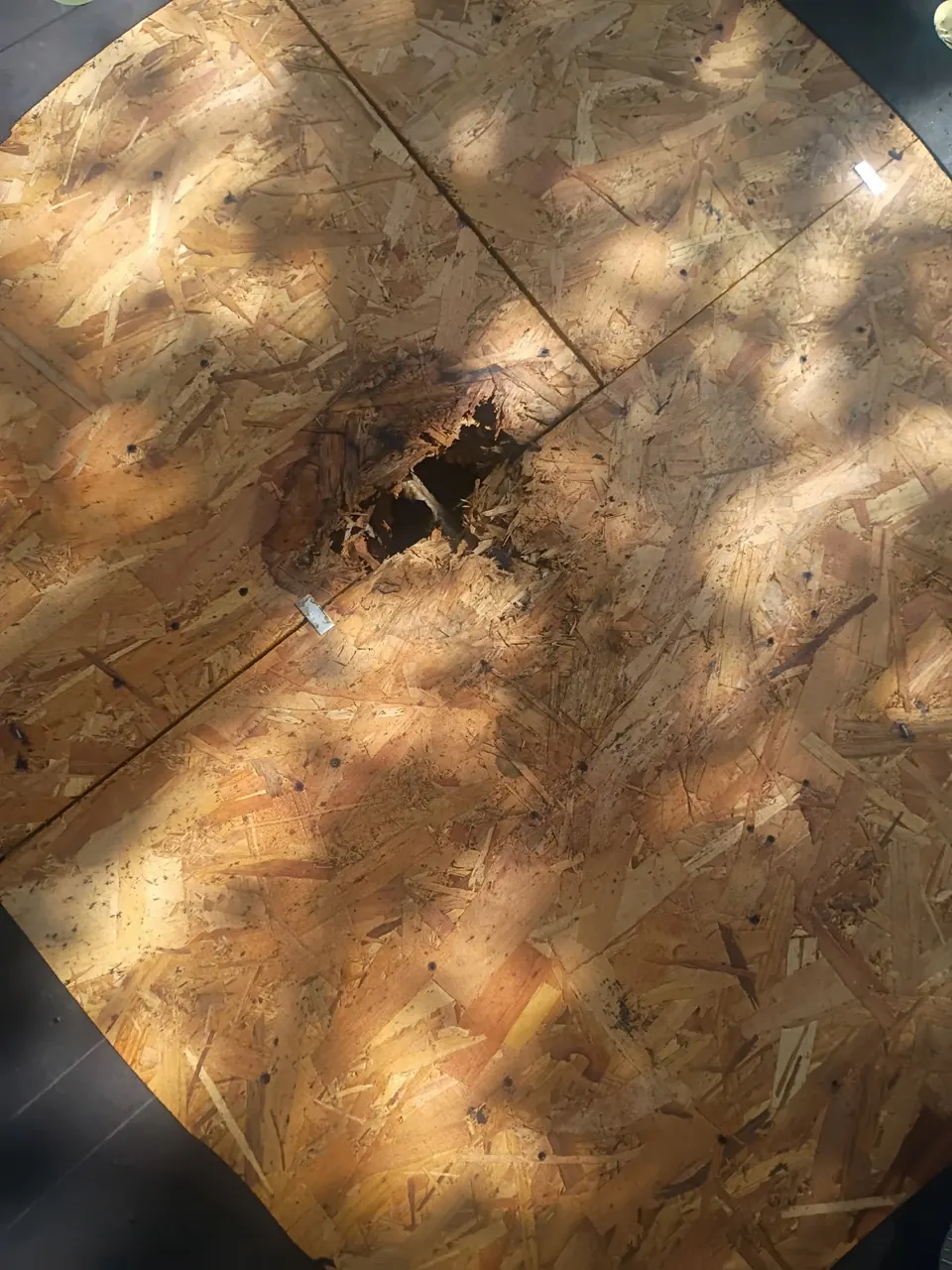 Exposed roof decking with a damaged opening during the documented Floresville roof replacement.