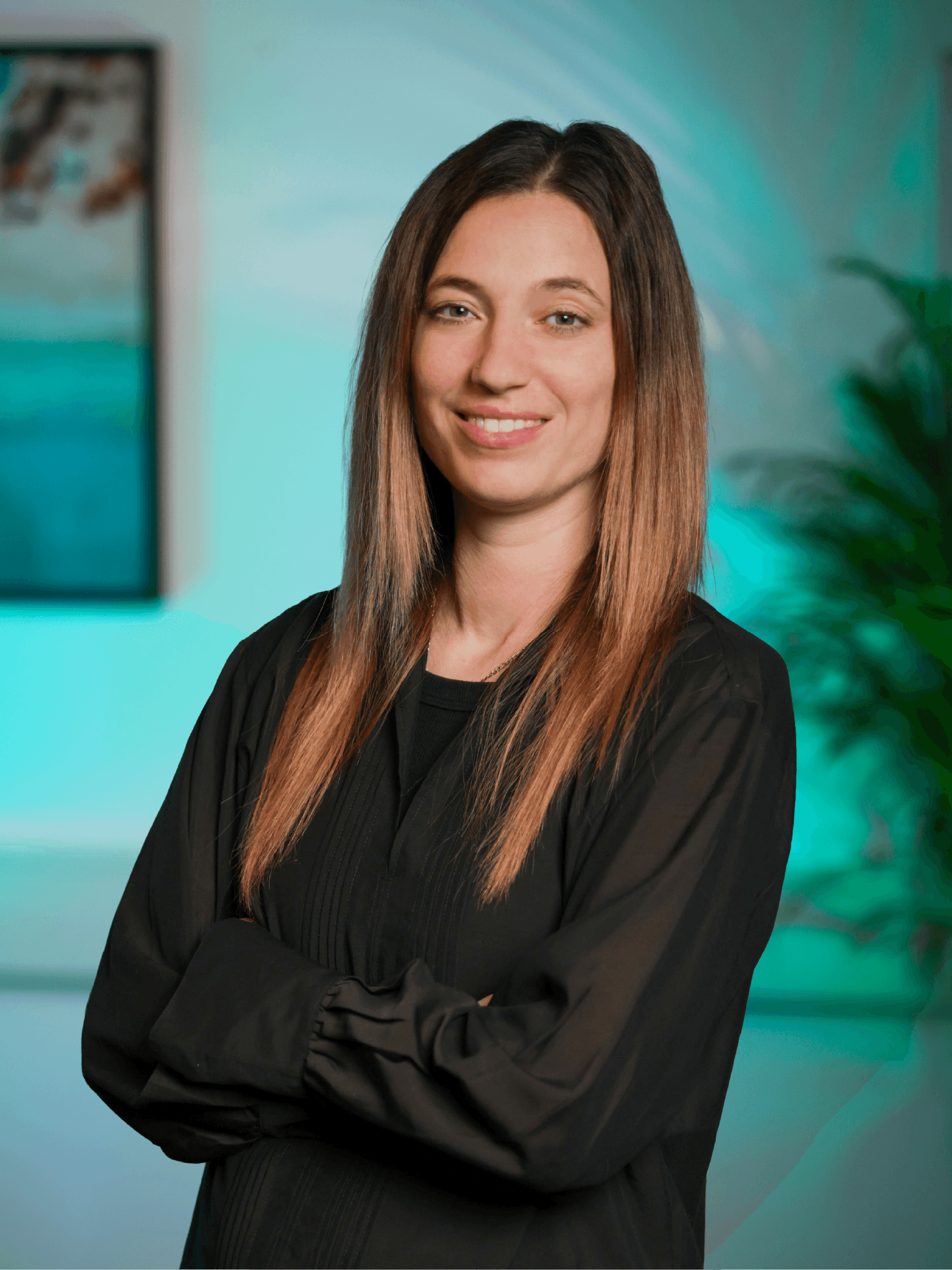 A woman with straight blonde hair wearing a light colored sweater looks away.