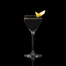 A closeup of a Vodka Martini drink against a dark background.