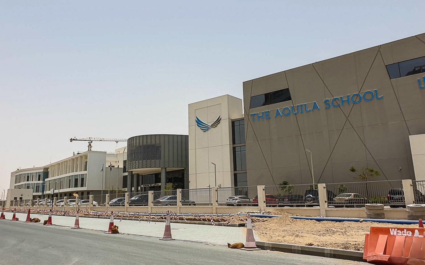 High-angle shot of luxury residential buildings and lush landscaping within the Dubailand Residence Complex.