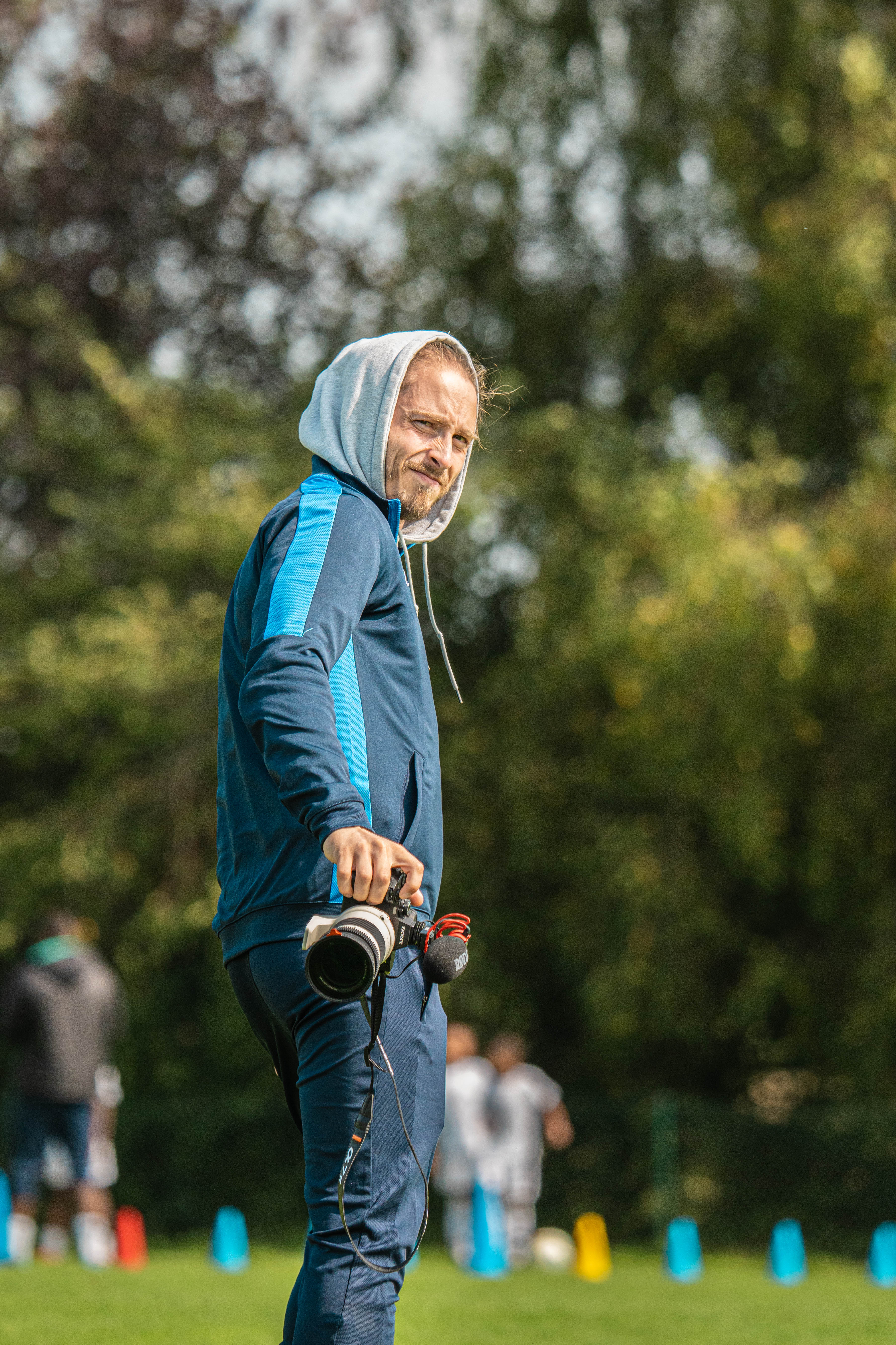 Person stand in front of a red sports oldtimer
