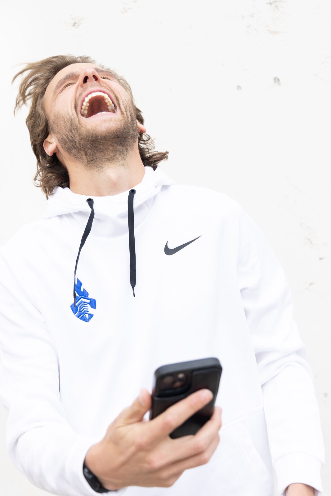 Nike shoot, an athlete laughing, phone in hand