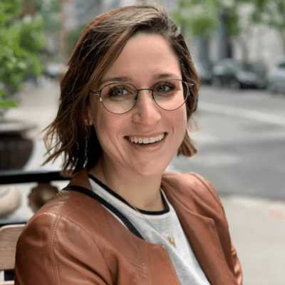 Outdoor headshot in an urban setting of Alyssa Friedberg