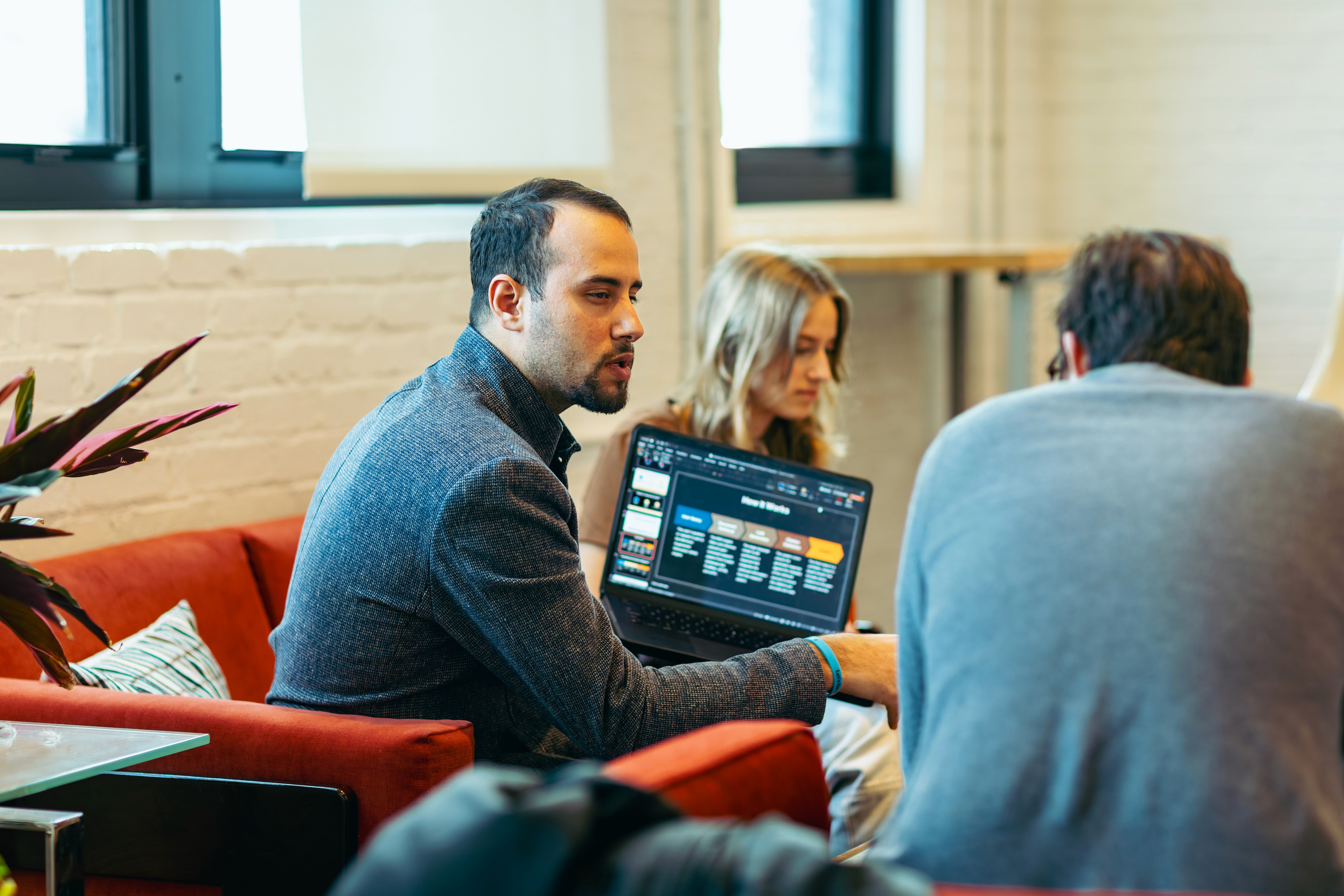 man wearing gray polo shirt beside dry-erase board