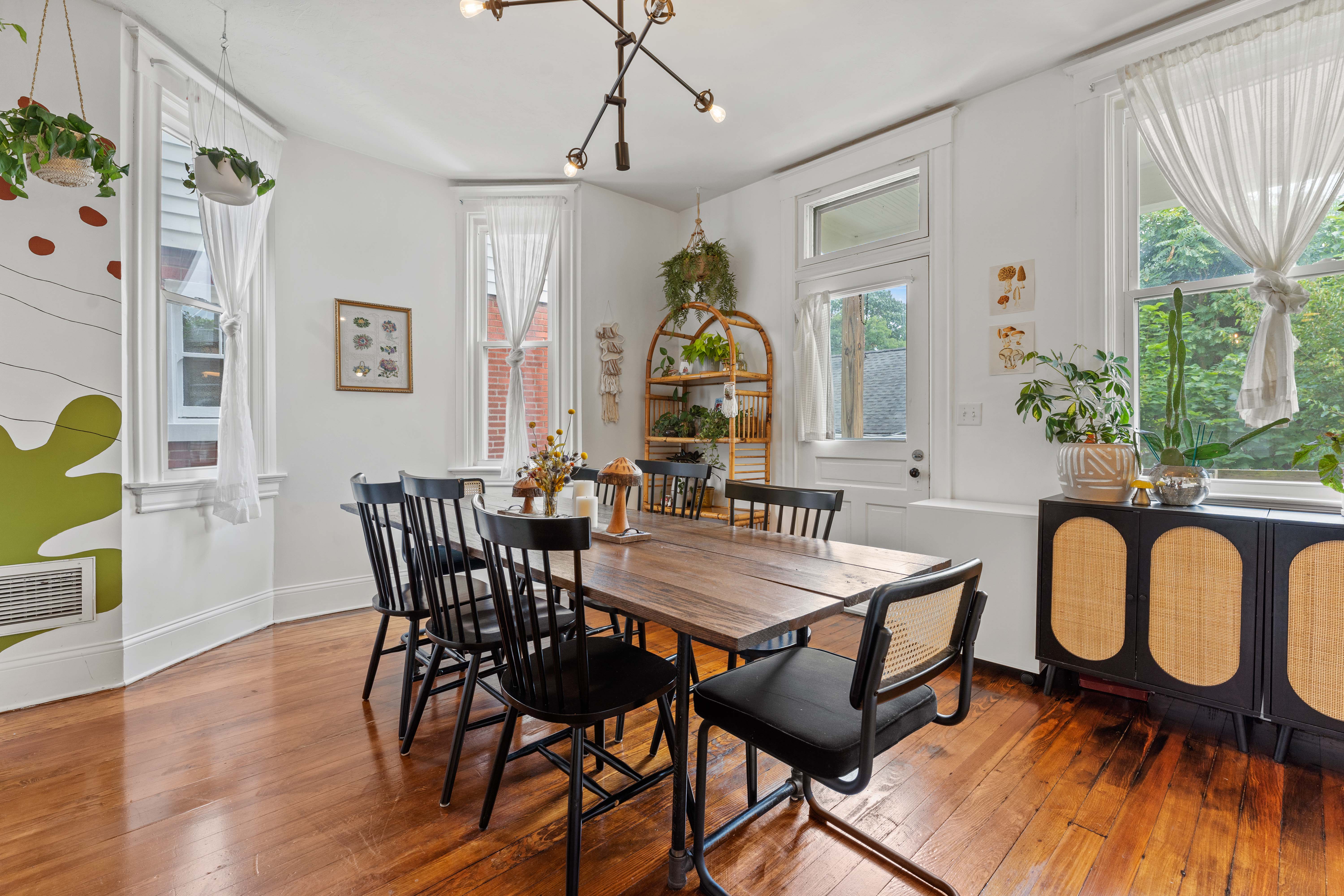 A man riding a bike down a street next to a trash can