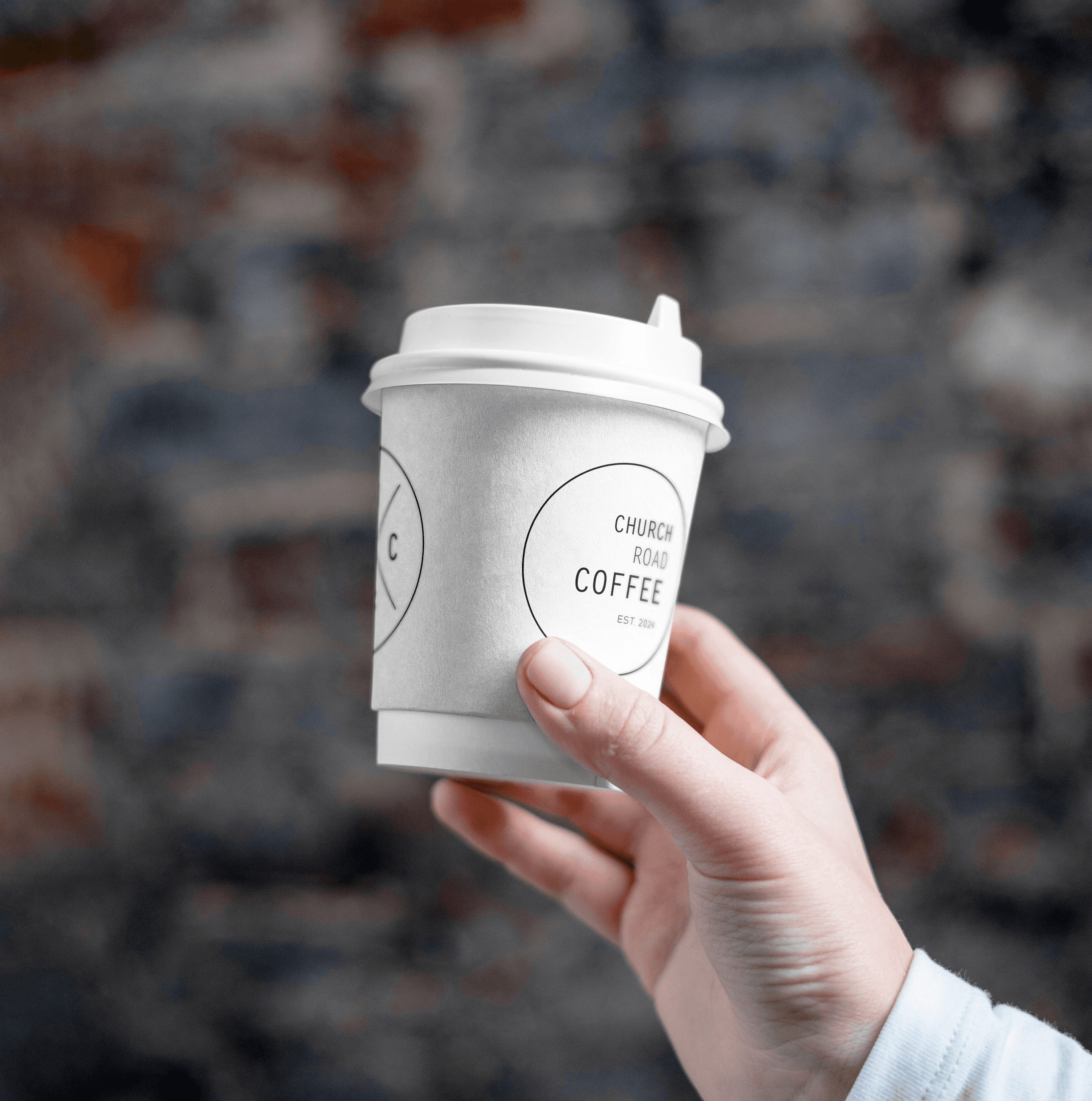 A close-up of a pink cocktail in a martini glass, set against a nighttime background with soft, blurred colors.
