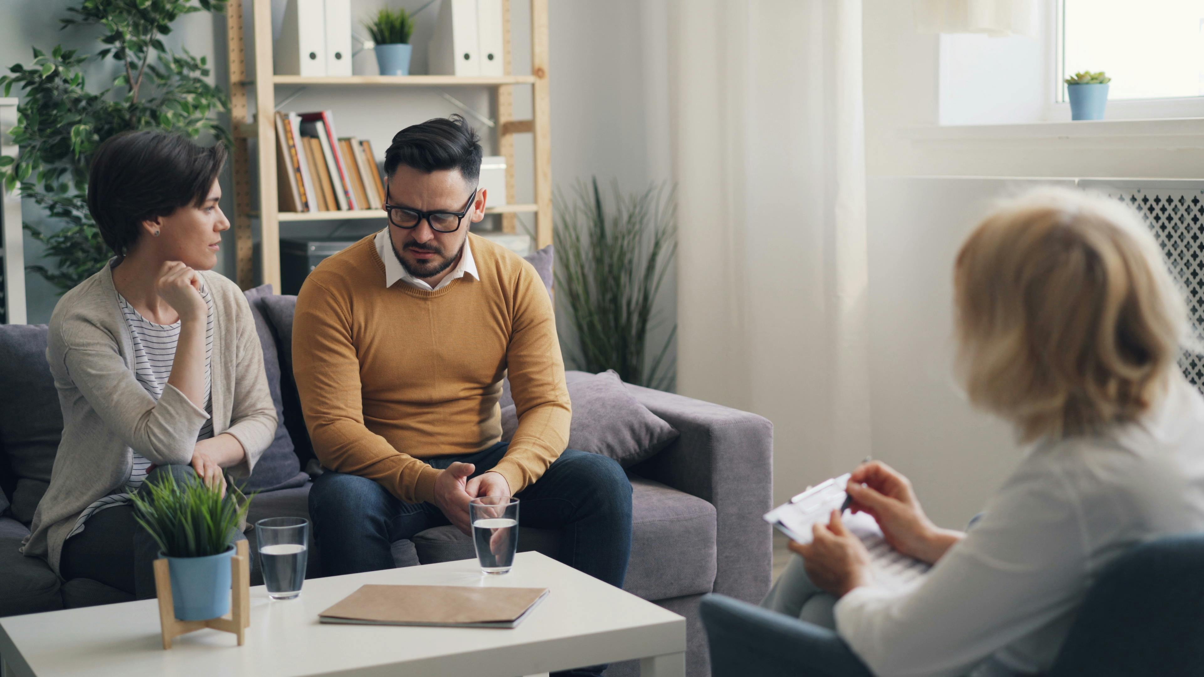 Conversion Truth for Families: Man in mustard sweater sitting next to woman on a therapist's couch