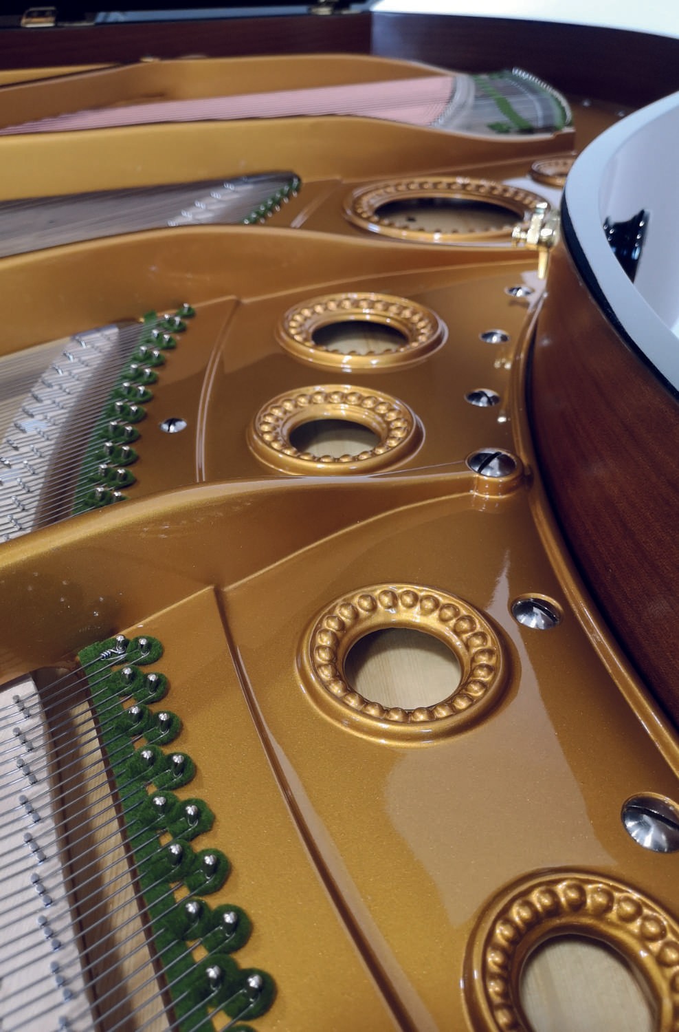 A macro shot of the restored iron frame with intricate golden accents and precision craftsmanship.