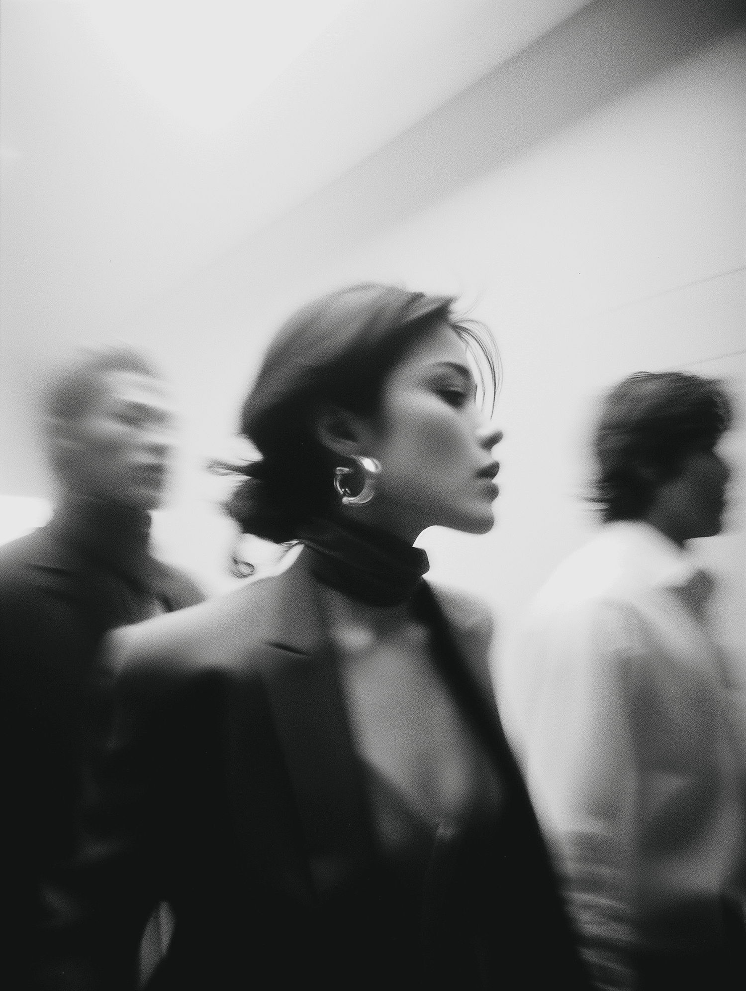 Woman in blazer walking through a crowded space with motion blur