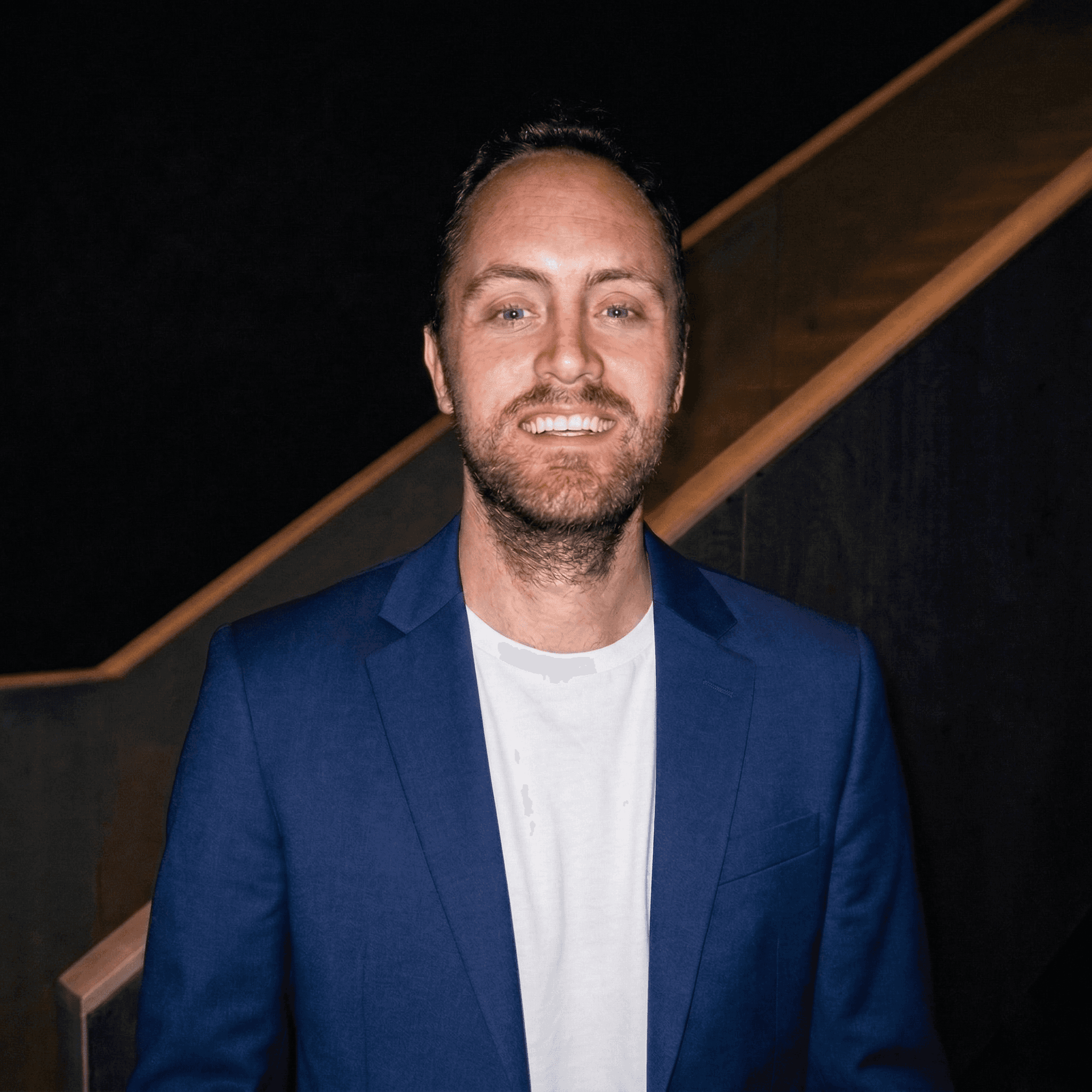A smiling woman writing on a piece of paper in her home