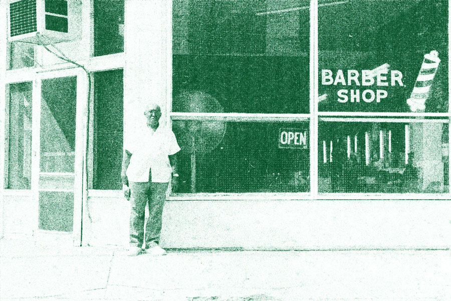 Man standing outside of barber shop