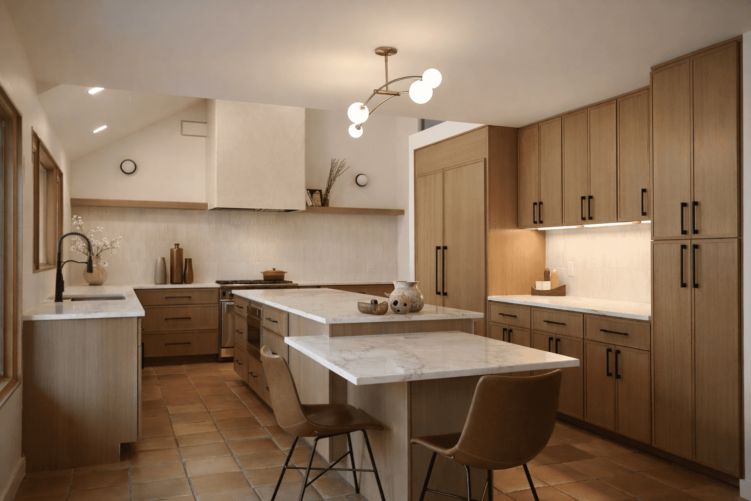 Custom white oak kitchen with marble island, plaster range hood and matte black hardware in Austin Texas home