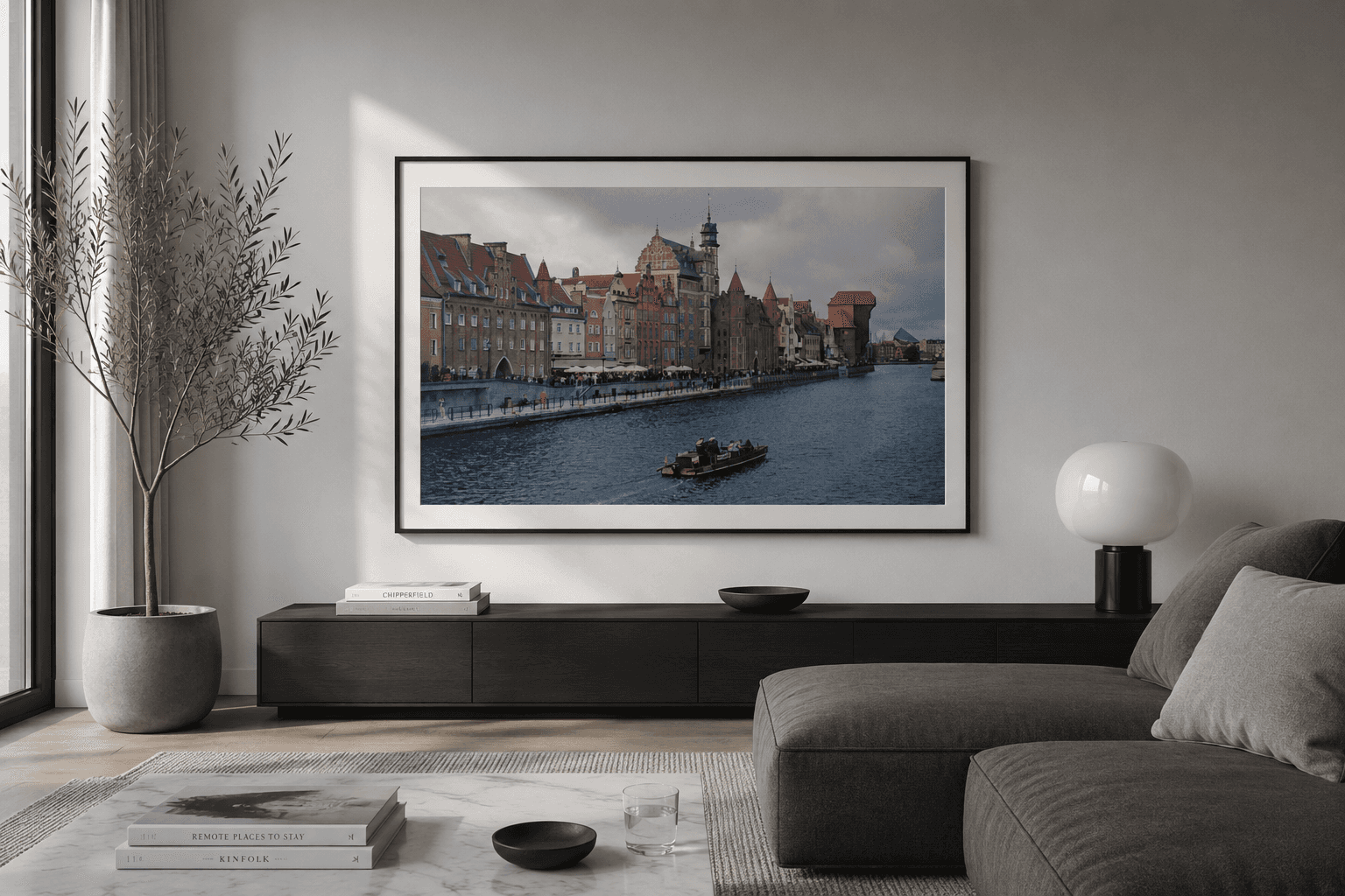 Black and white fine art film photograph of a lone fisherman beside the water near Centralbron in Stockholm, captured on Fomapan 200 and printed on Hahnemühle William Turner paper.