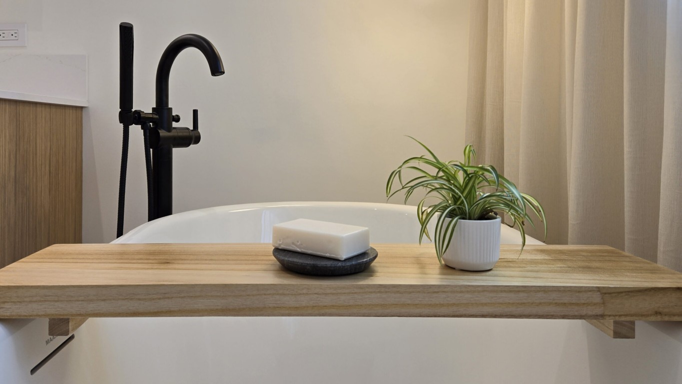 Image of KHD Homes luxurious bathroom design featuring a freestanding tub with modern faucet and spa-like amenities.