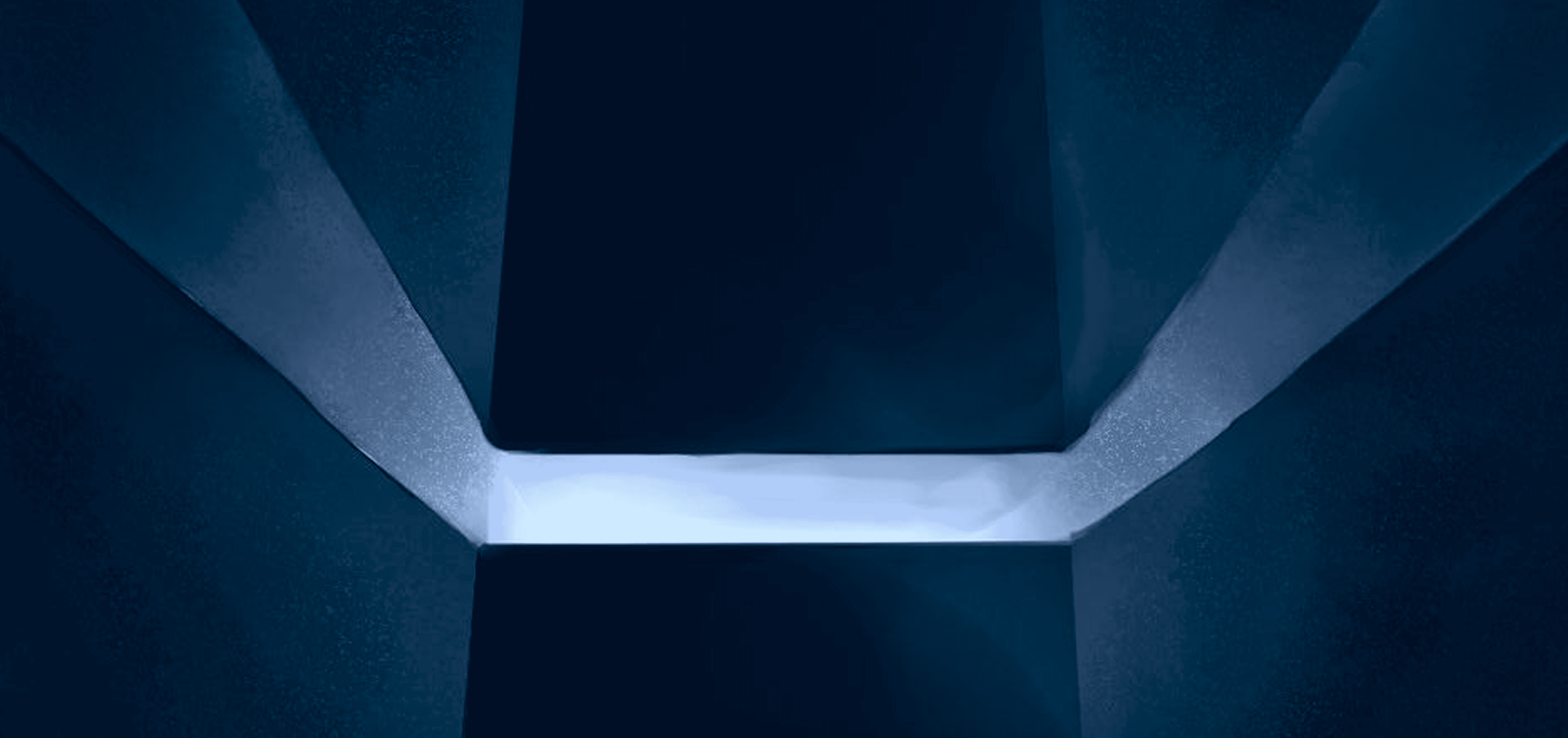 Futuristic blue light illuminating angular shapes, symbolising advanced technology and modern digital systems.