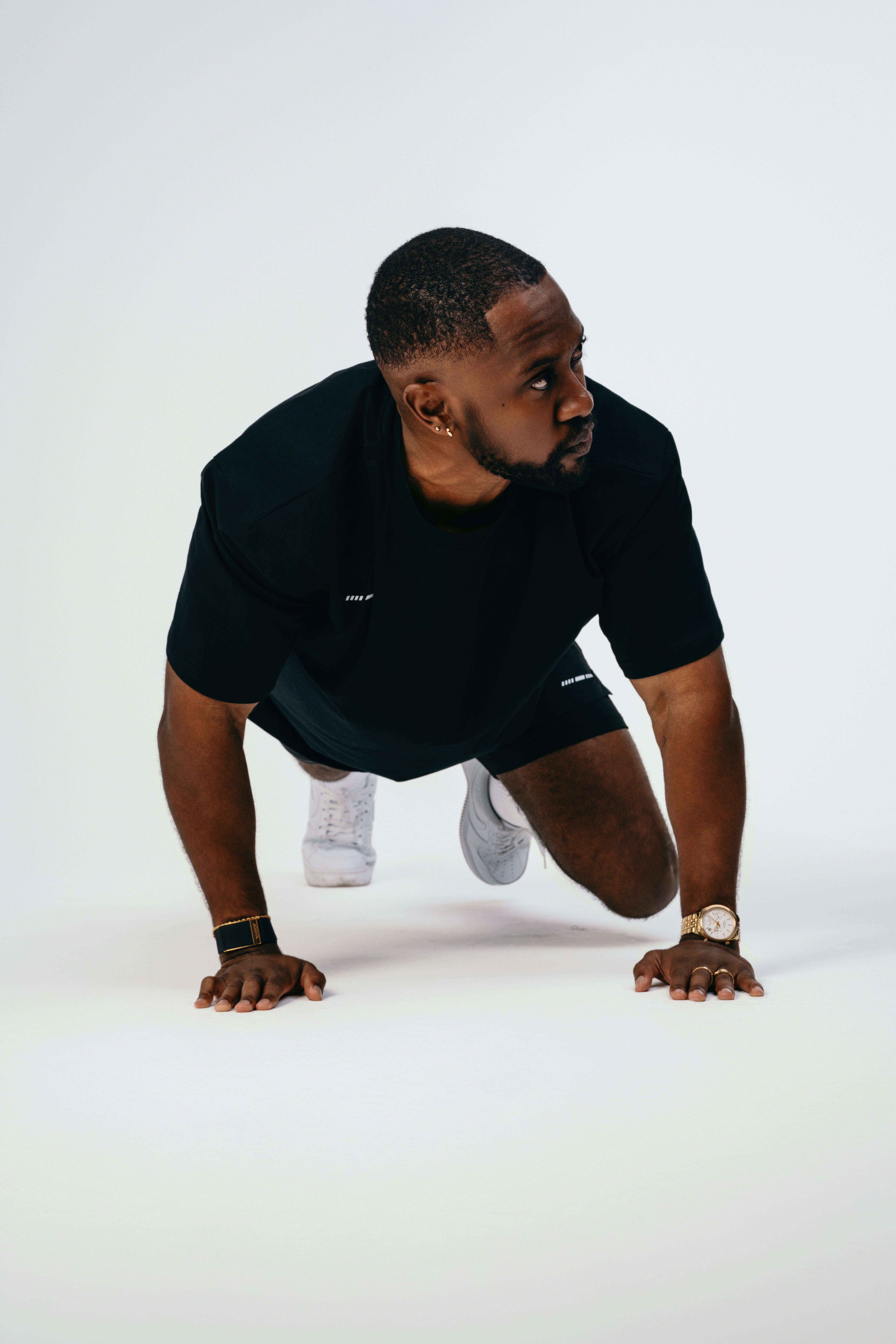 A man in a black shirt is doing push ups