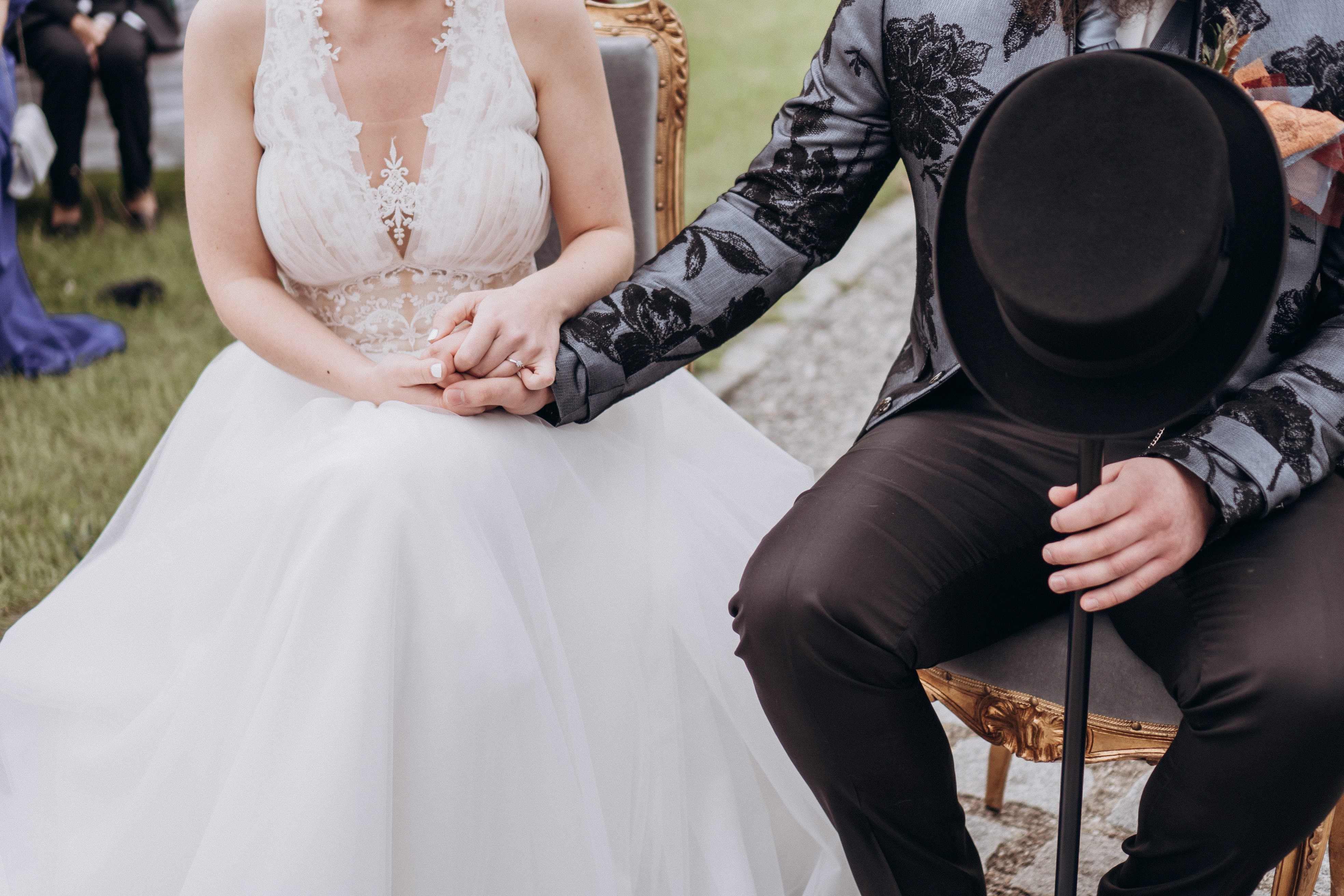 Detailaufnahme Hochzeitsfotografie in Bogen – Braut und Bräutigam halten sich bei der Trauung an den Händen.