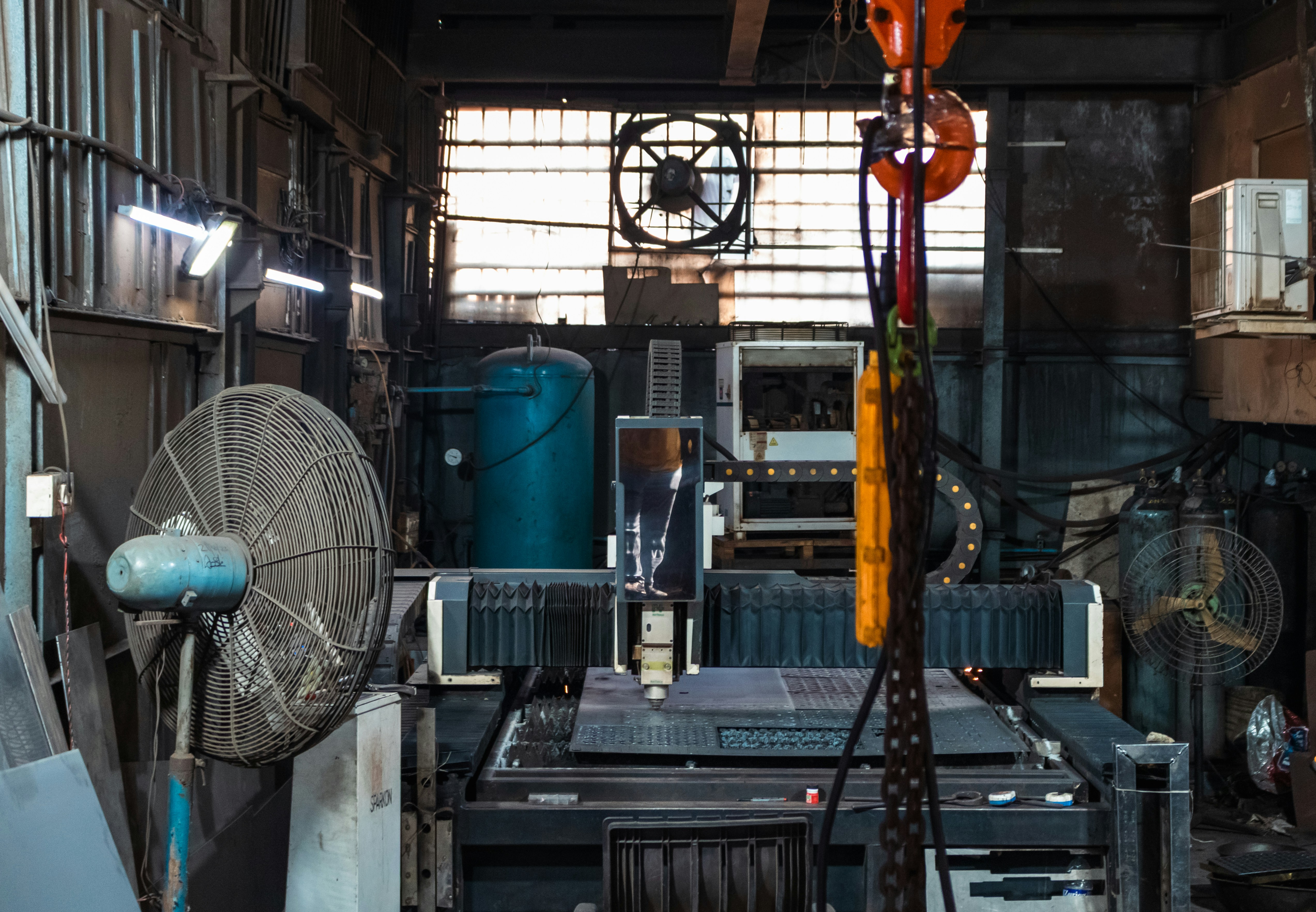 Industrial workshop with machinery and fans.