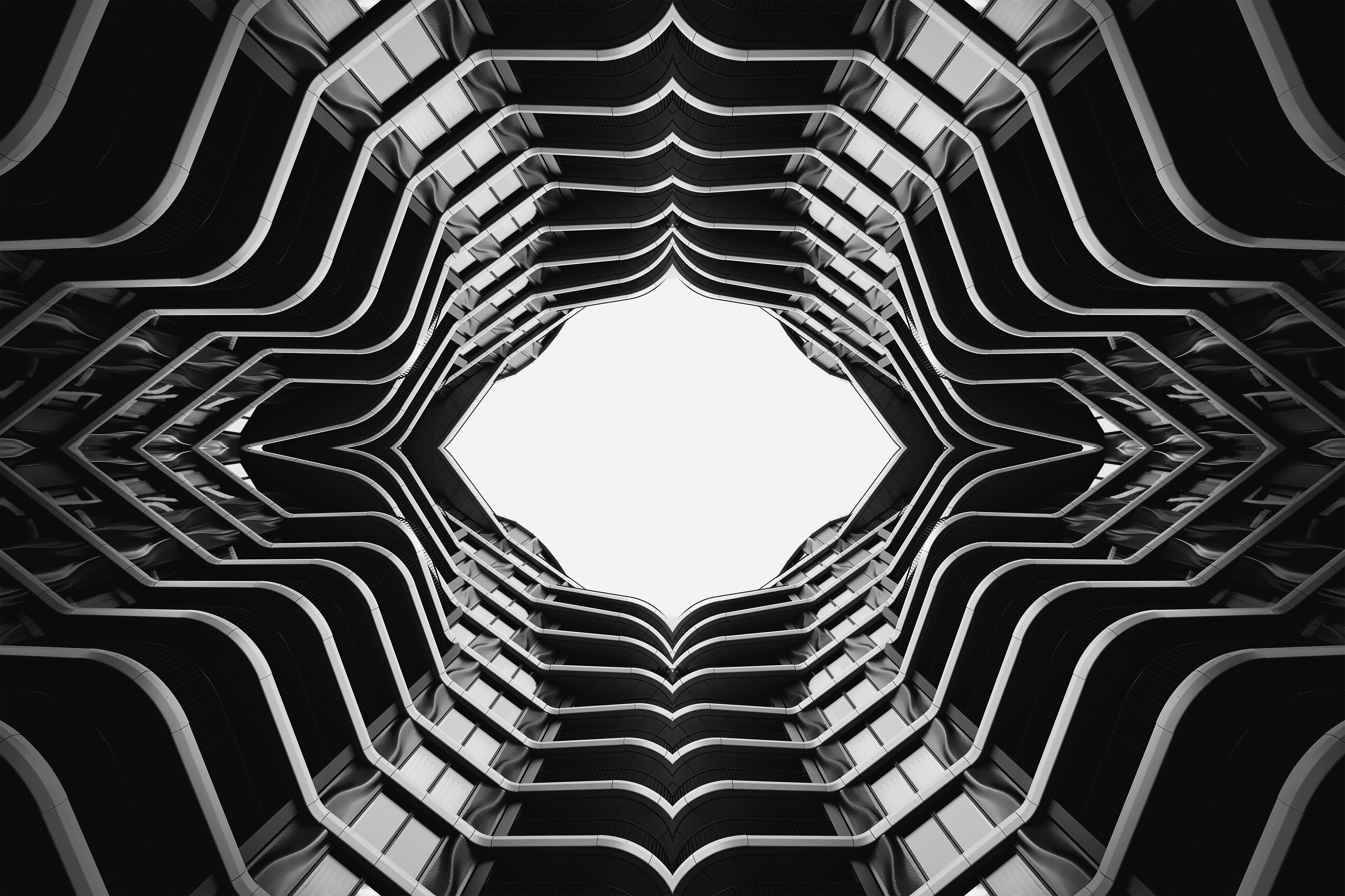 Abstract geometric pattern of building balconies against bright sky