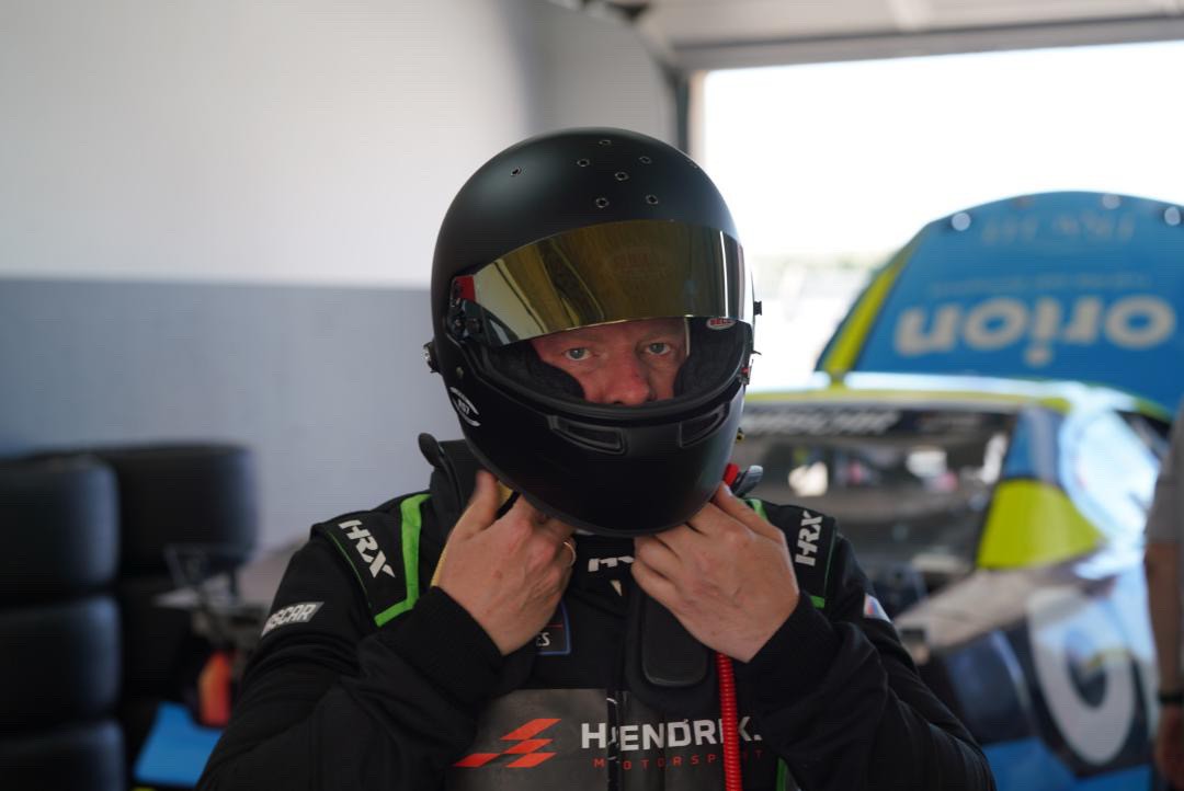 Henrik Peters putting on his helmet in the garage