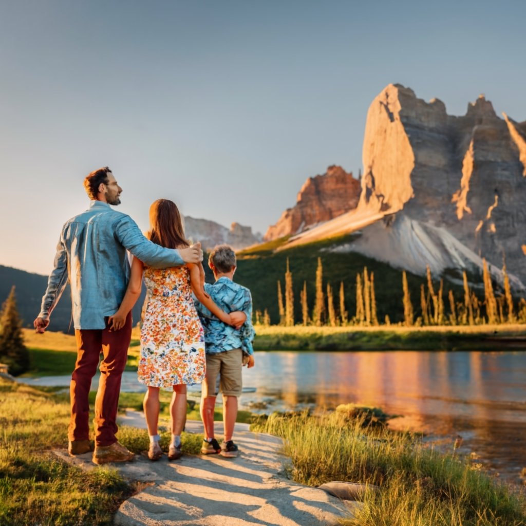 Happy family standing in front of a Canadian landmark, representing the dream of living in Canada.