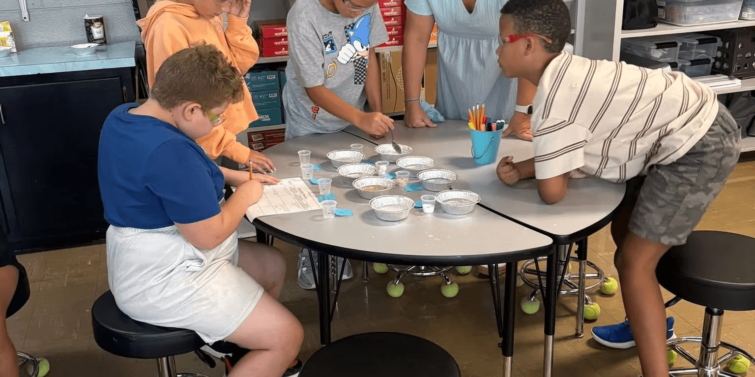 Students gathered around a table at Alpine Crest Elementary School.
