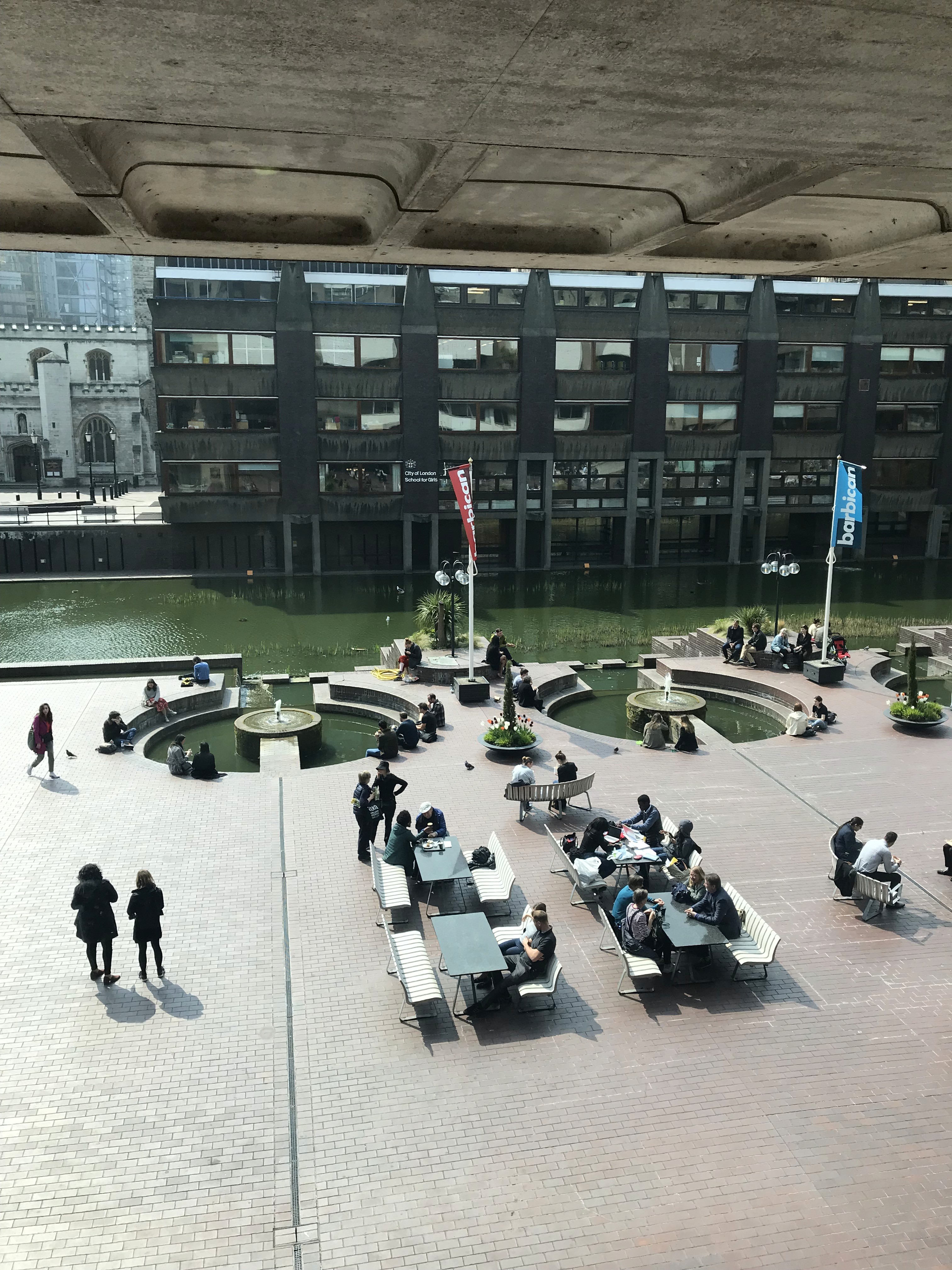 people in a large building with Tate Modern in the background