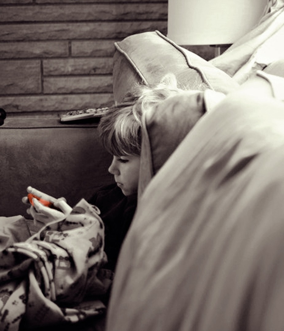 a Boy watching PBS programming on his mobile device