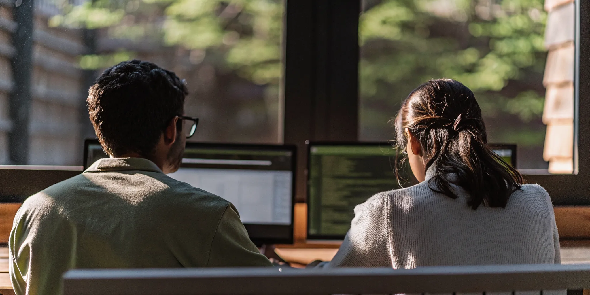 Compliance analyst and internal audit lead reviewing control evidence in an enterprise operations room