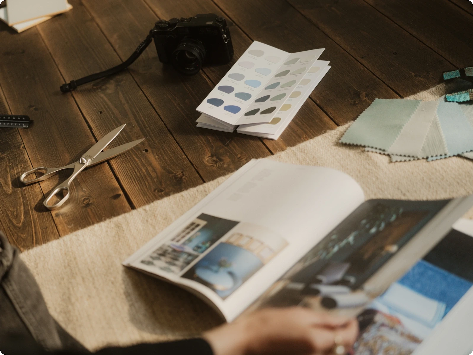 HORL Scissors on wooden floor with various fabric swatches