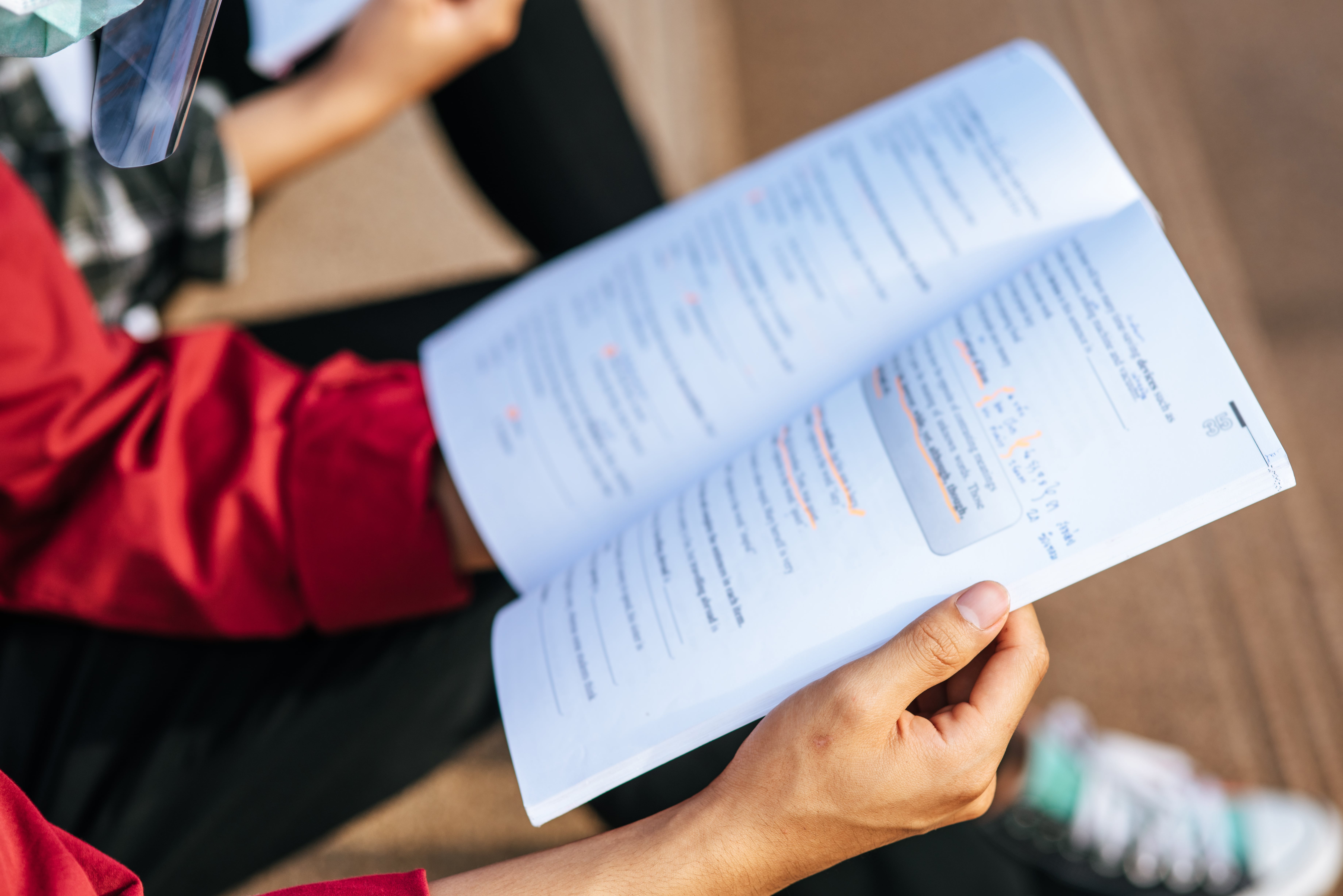 A student reading a text book.