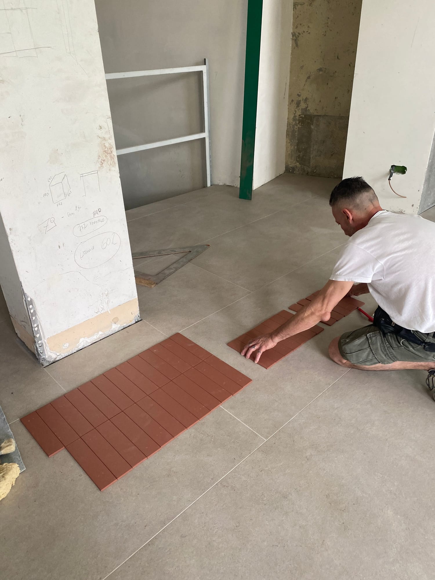 Laying out a terracotta tile sample on the floor