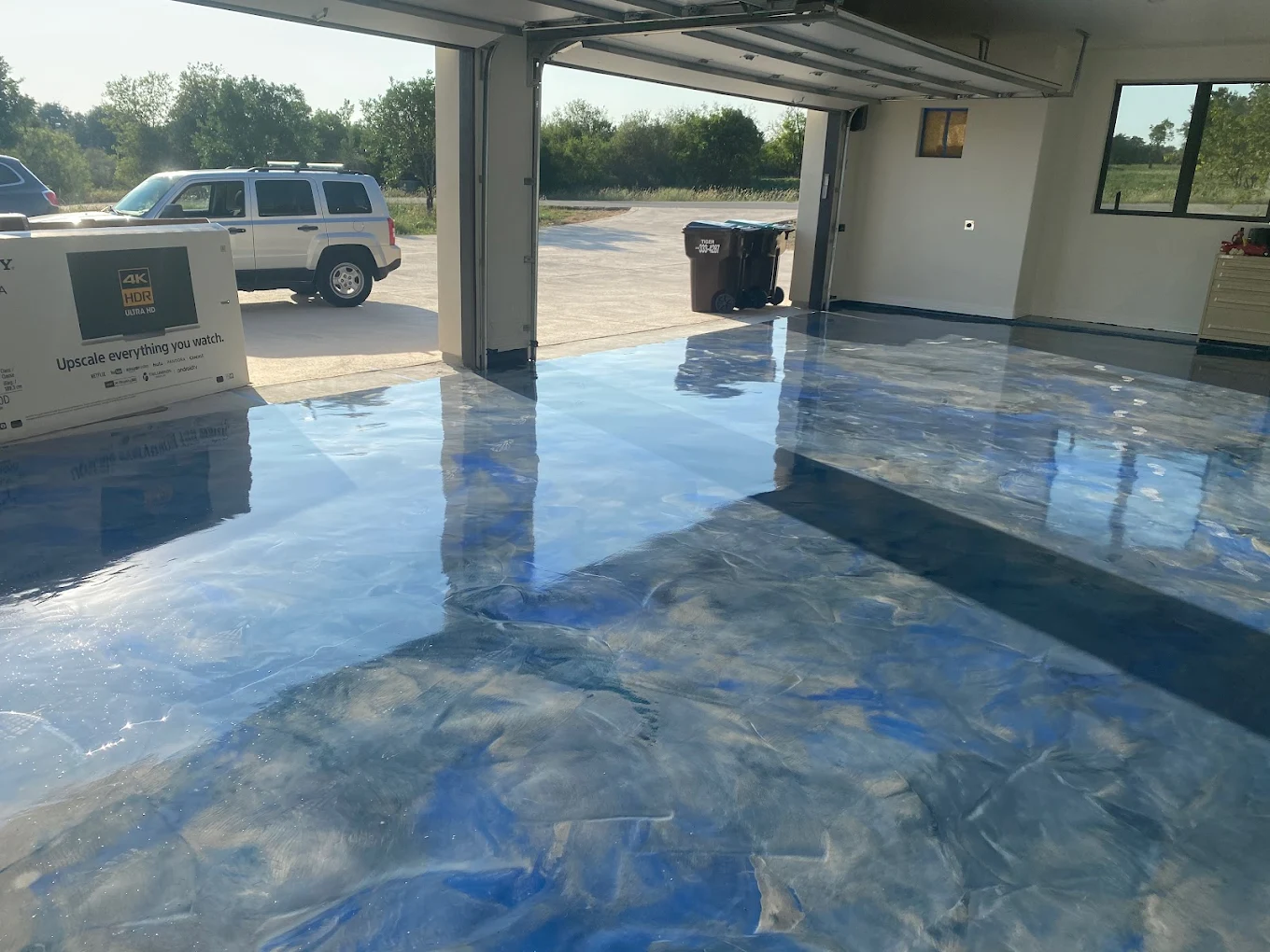 Blue metallic epoxy floor coating in garage