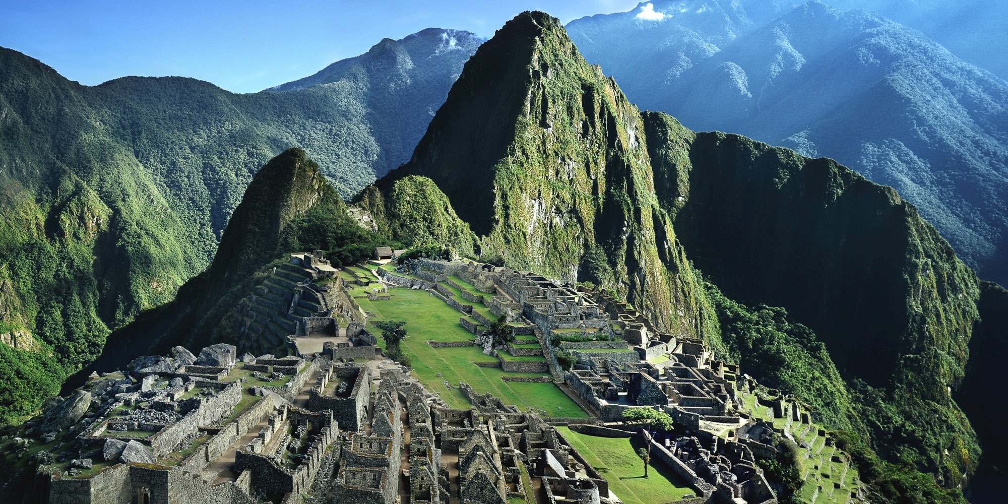 Machu Picchu, an architectural marvel of the Incan Empire, stands 2,430 meters above sea level. Its precisely cut granite blocks and intricate stone terraces seamlessly blend with the stunning Peruvian Andes and Amazon Basin landscape.