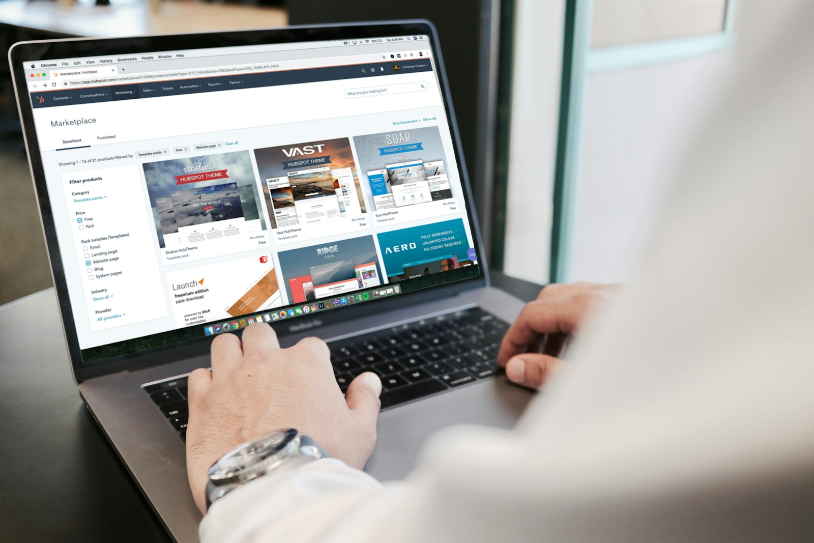 Designer browsing website template options on a laptop