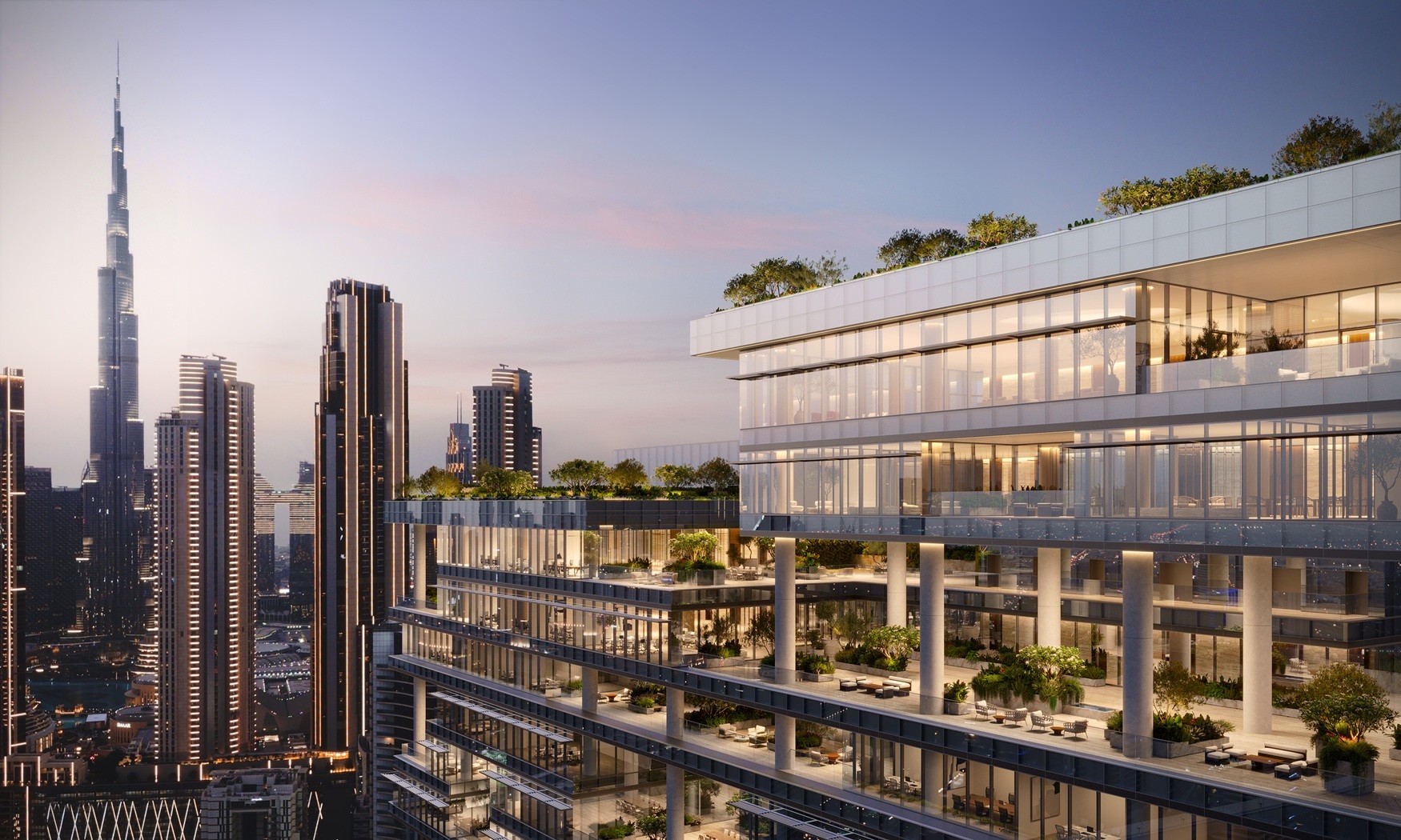 Beachfront apartment complex "Enara by Omniyat" illuminated by a vibrant sunset, casting warm hues over the scene.