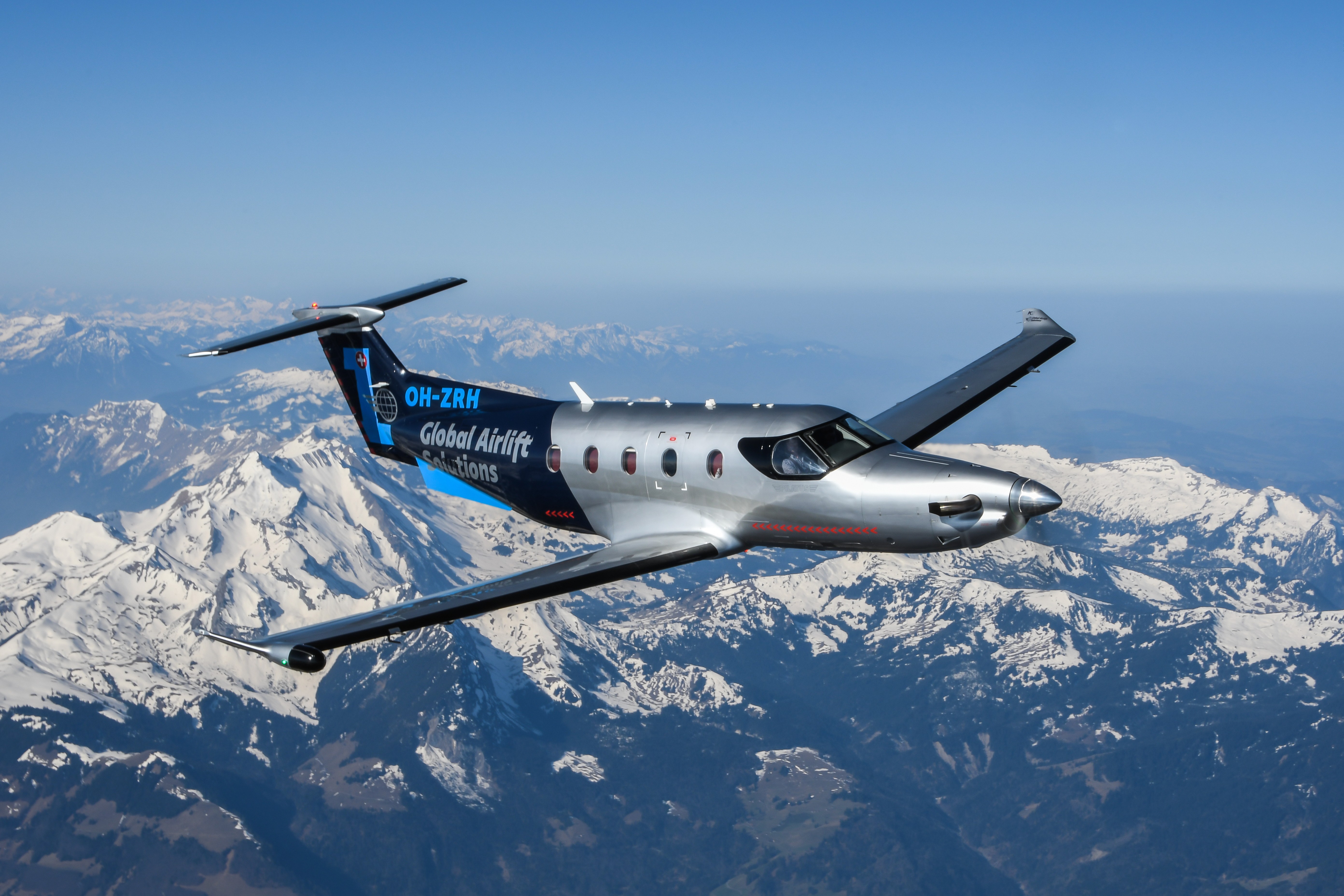 Pilatus PC-12 flying over snowy mountains