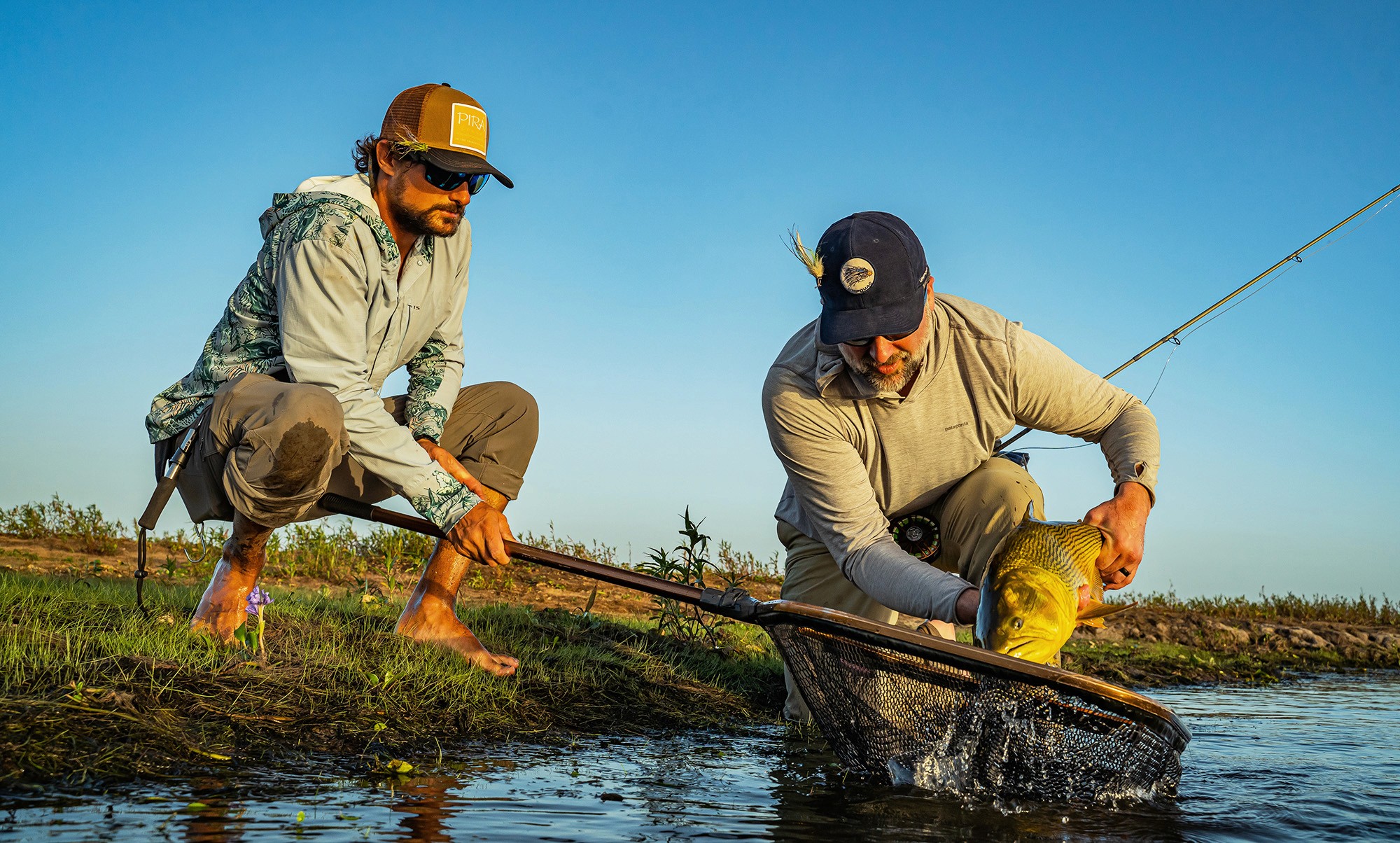 Two fishermen handling fish