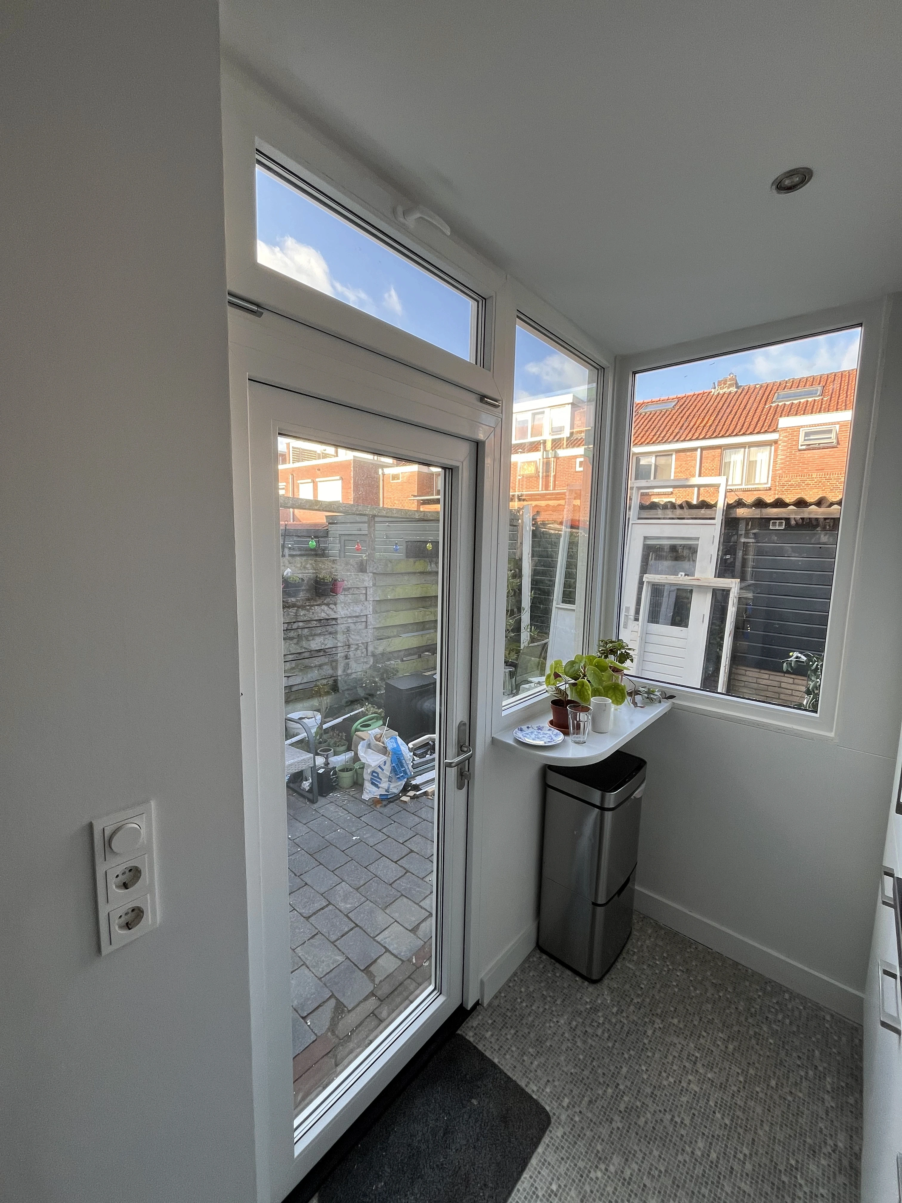utility man standing in scissor platform cleaning glass window