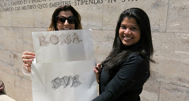 two women holding paper with type