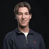 Man in navy quarter-zip sweater