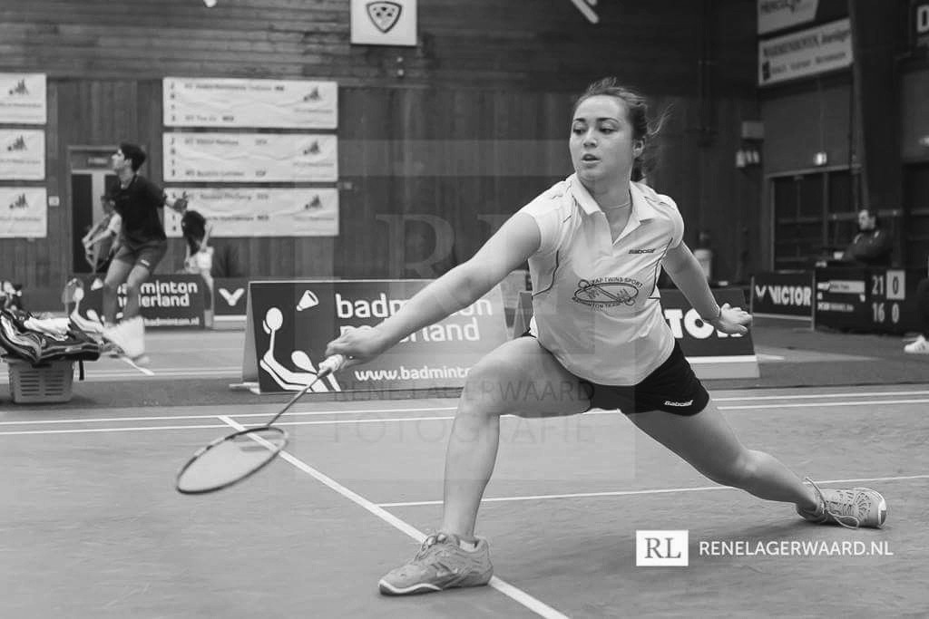 A black and white photo of Tsui lunging for a shot at a badminton tournament in the Netherlands