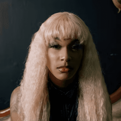 man wearing green crew-neck top and eyeglasses with black frames looking at side