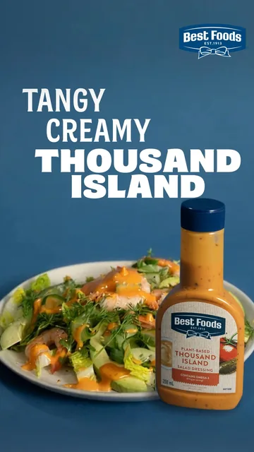 A prawn salad beside a bottle of Thousand Island dressing