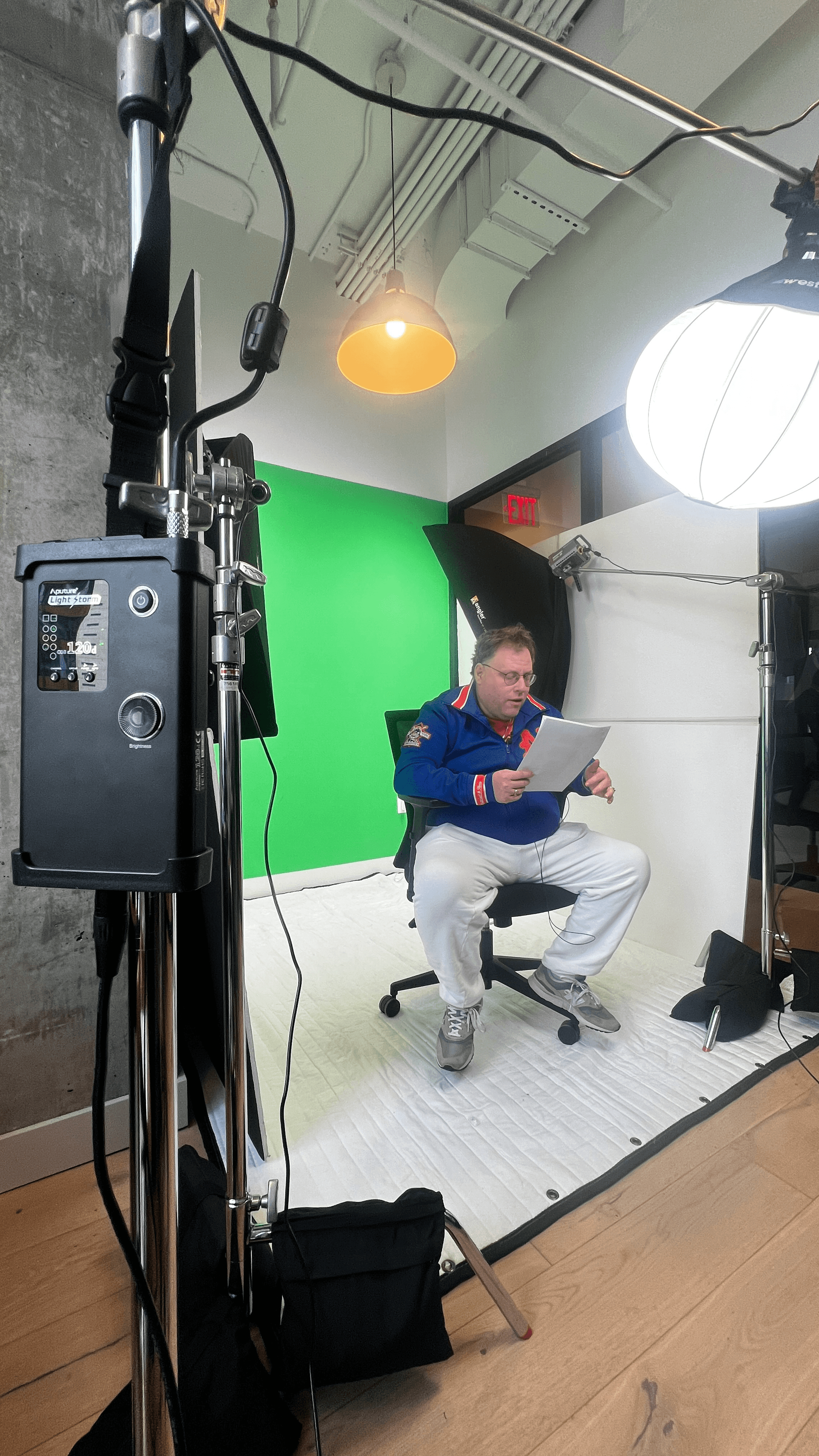 Host reading the script in the green screen studio setup